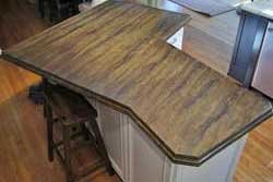 Acid stained concrete island top with 2 inch thick ogee edge design